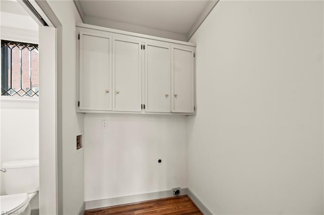 washroom with washer hookup, electric dryer hookup, baseboards, cabinet space, and wood finished floors