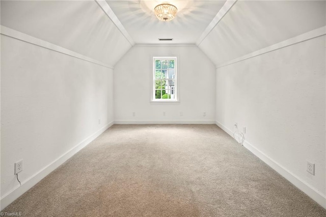 additional living space featuring lofted ceiling, carpet, visible vents, and baseboards
