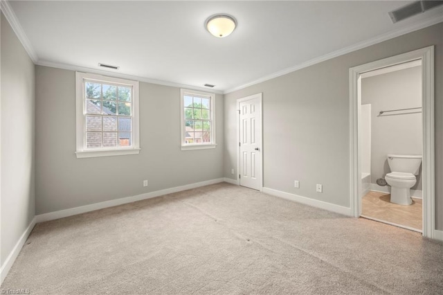 unfurnished bedroom featuring baseboards, visible vents, ornamental molding, and light colored carpet