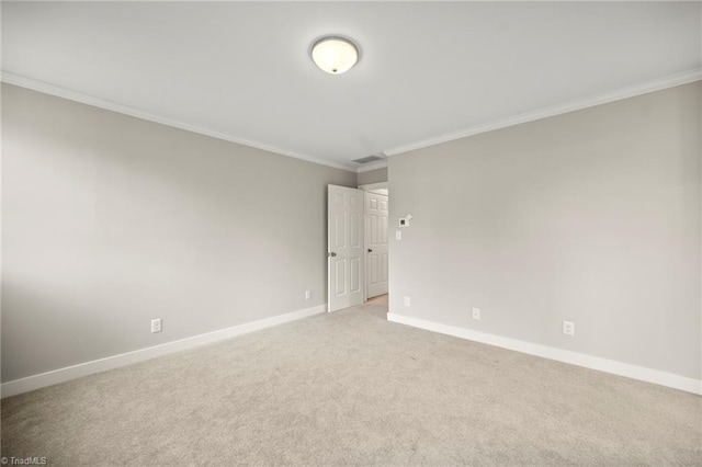 unfurnished room featuring visible vents, light carpet, ornamental molding, and baseboards