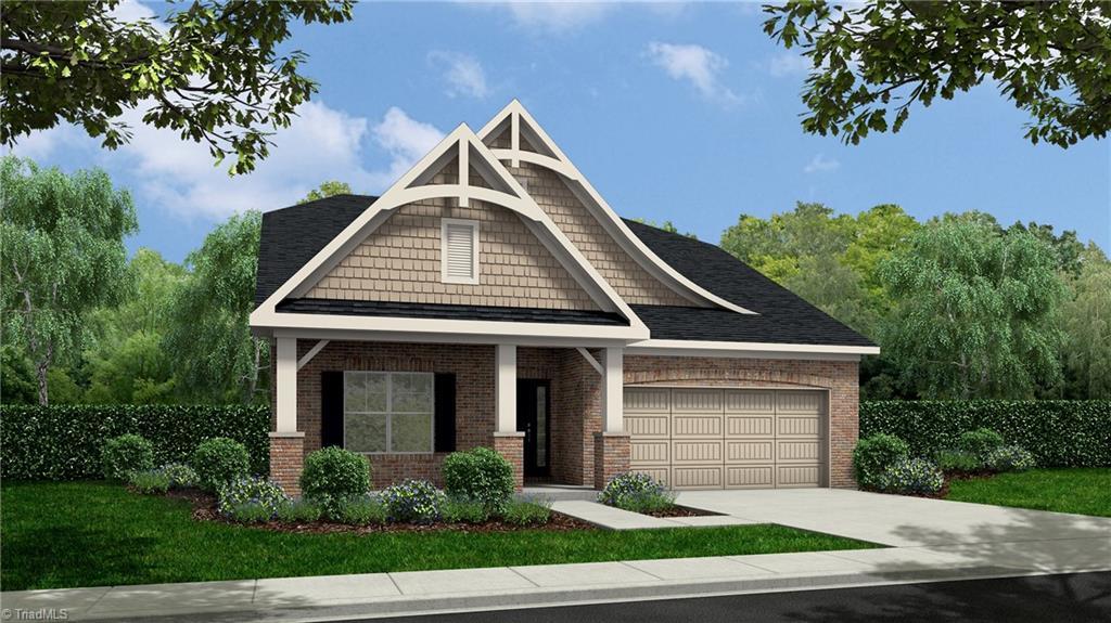 view of front of property featuring brick siding, driveway, and an attached garage