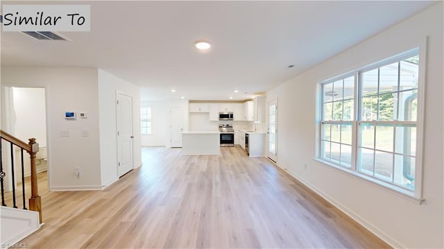 unfurnished living room with light wood-type flooring