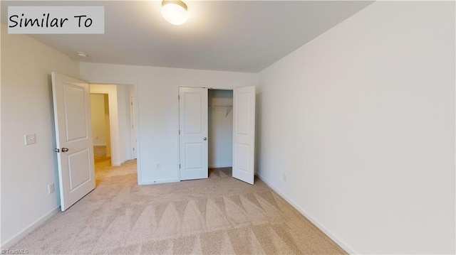 unfurnished bedroom with light carpet and a closet