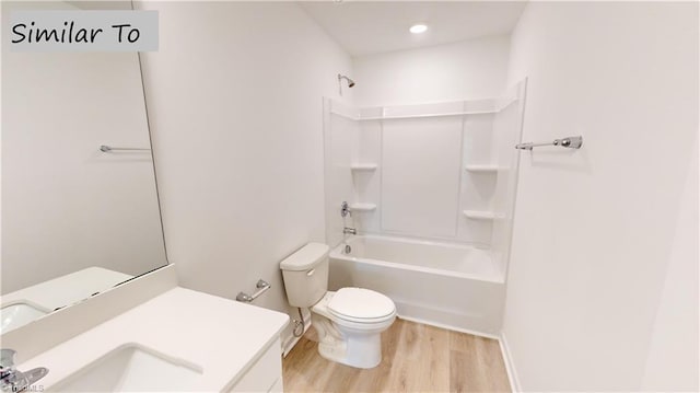 full bathroom featuring hardwood / wood-style floors, vanity, bathtub / shower combination, and toilet