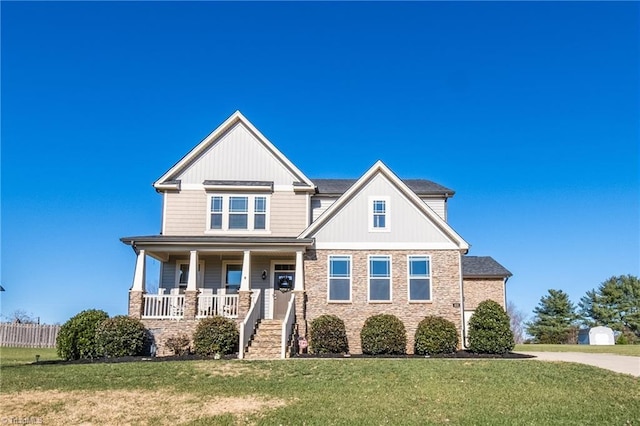 craftsman inspired home with covered porch and a front lawn