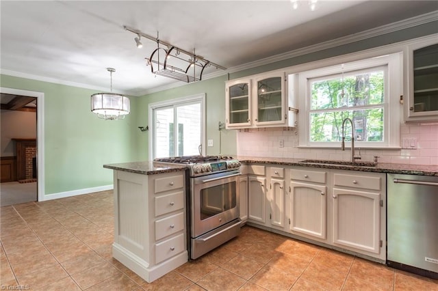 4602 Forest Glen Rd, Greensboro, NC 27410 - kitchen with appliances with stainless steel finishes, a sink, decorative backsplash, a peninsula, and light tile patterned floors