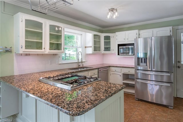 4602 Forest Glen Rd, Greensboro, NC 27410 - kitchen with appliances with stainless steel finishes, a sink, a peninsula, decorative backsplash, and ornamental molding