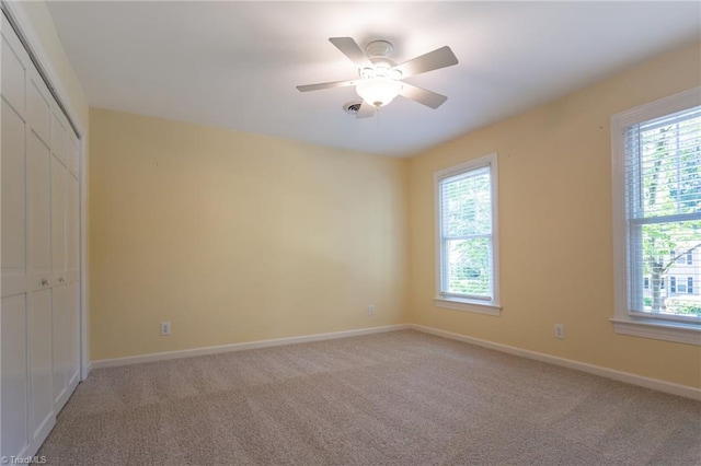 4602 Forest Glen Rd, Greensboro, NC 27410 - unfurnished bedroom with multiple windows, light carpet, a closet, and baseboards