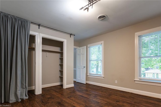 4602 Forest Glen Rd, Greensboro, NC 27410 - unfurnished bedroom featuring dark wood finished floors, multiple windows, and baseboards