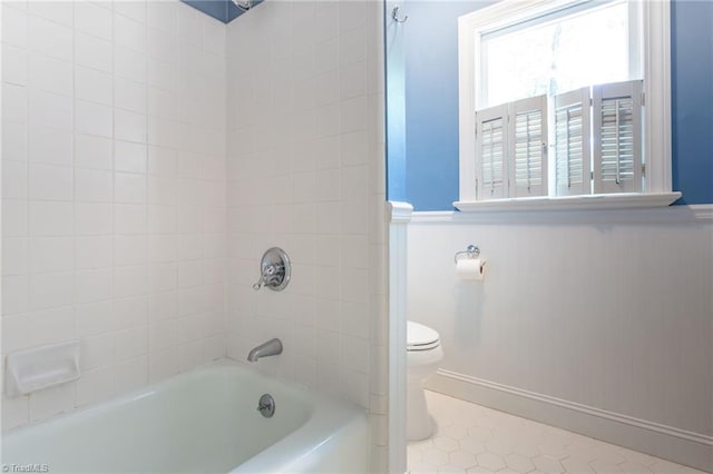4602 Forest Glen Rd, Greensboro, NC 27410 - bathroom featuring toilet, tub / shower combination, a wainscoted wall, tile patterned floors, and baseboards