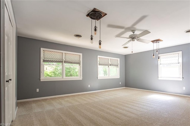 4602 Forest Glen Rd, Greensboro, NC 27410 - spare room featuring light carpet, a ceiling fan, and baseboards