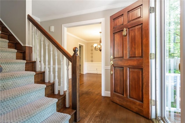4602 Forest Glen Rd, Greensboro, NC 27410 - foyer entrance with stairway, dark wood-type flooring, crown molding, a chandelier, and a wainscoted wall