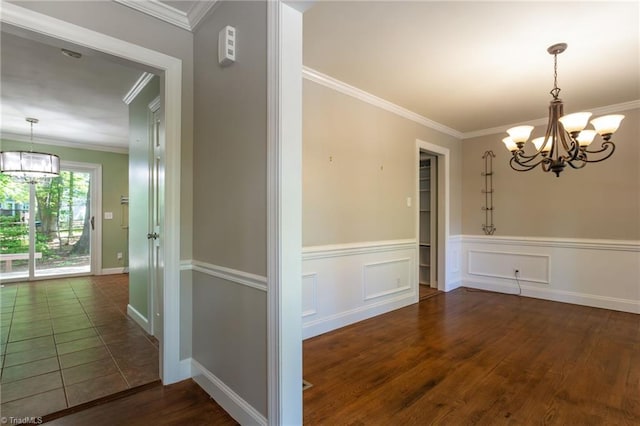 4602 Forest Glen Rd, Greensboro, NC 27410 - unfurnished dining area featuring a chandelier, ornamental molding, wood finished floors, wainscoting, and baseboards