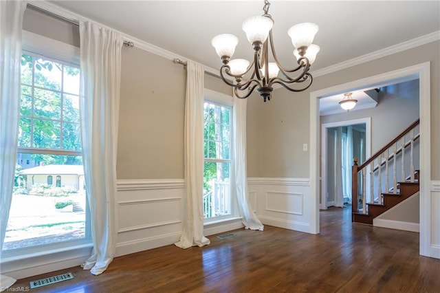 4602 Forest Glen Rd, Greensboro, NC 27410 - unfurnished dining area with a chandelier, healthy amount of natural light, dark wood-style floors, wainscoting, and stairs