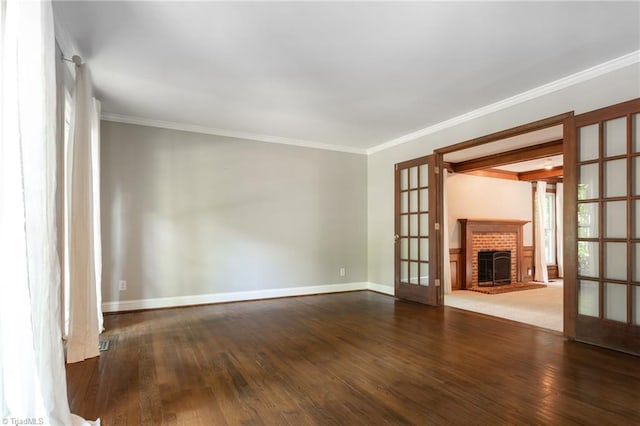 4602 Forest Glen Rd, Greensboro, NC 27410 - unfurnished living room with french doors, wood-type flooring, baseboards, ornamental molding, and a brick fireplace