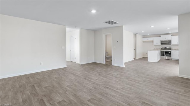 821 Merriweather Dr, King, NC 27021 - unfurnished living room with light wood-style flooring, baseboards, and recessed lighting