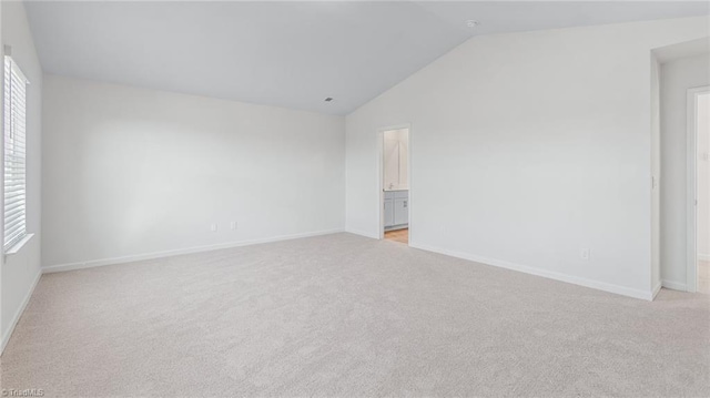 821 Merriweather Dr, King, NC 27021 - empty room with vaulted ceiling, light carpet, and baseboards