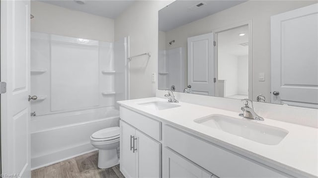 821 Merriweather Dr, King, NC 27021 - bathroom with double vanity, wood finished floors, toilet, and washtub / shower combination