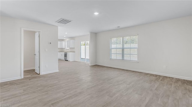 821 Merriweather Dr, King, NC 27021 - unfurnished living room featuring baseboards, light wood-style flooring, and recessed lighting