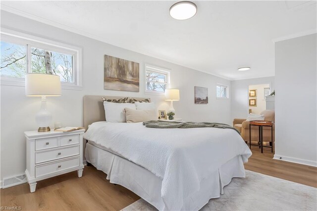 4566 Fork Rd, Norwood, NC 28128 - bedroom featuring light wood-style flooring, crown molding, and baseboards