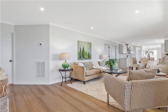 4566 Fork Rd, Norwood, NC 28128 - living area featuring light wood-style floors, ornamental molding, recessed lighting, and baseboards