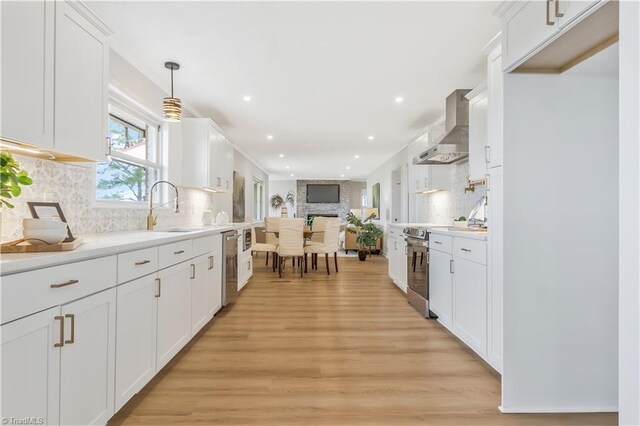 4566 Fork Rd, Norwood, NC 28128 - kitchen with wall chimney exhaust hood, tasteful backsplash, light wood-type flooring, white cabinets, and recessed lighting