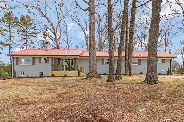4566 Fork Rd, Norwood, NC 28128 - view of front facade featuring brick siding, covered porch, a chimney, metal roof, and a front lawn