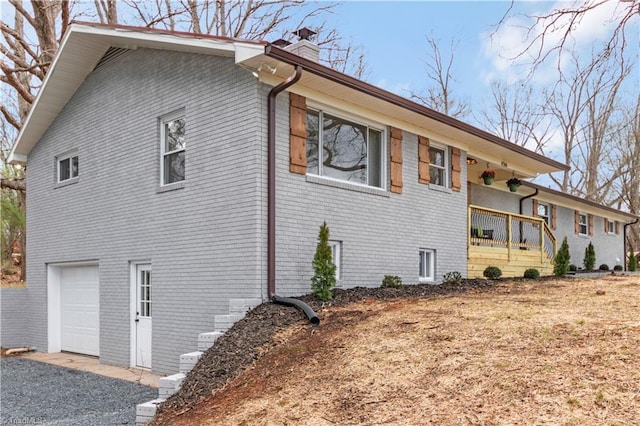 4566 Fork Rd, Norwood, NC 28128 - view of side of home featuring brick siding, a chimney, a garage, and covered porch