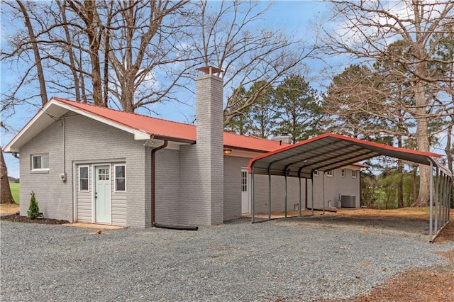 4566 Fork Rd, Norwood, NC 28128 - view of front of property with driveway, a carport, central AC, a chimney, and brick siding