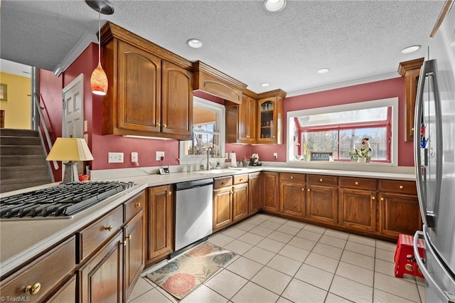 307 Jackson St, Mebane, NC 27302 - kitchen with stainless steel appliances, sink, light tile patterned floors, and decorative light fixtures