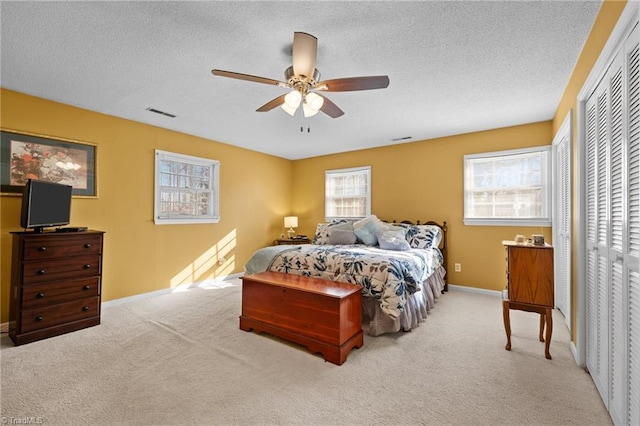 307 Jackson St, Mebane, NC 27302 - carpeted bedroom with ceiling fan and a textured ceiling