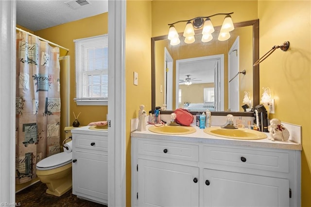 307 Jackson St, Mebane, NC 27302 - bathroom with vanity, ceiling fan, and toilet