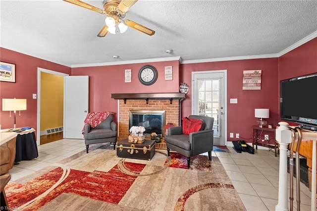 307 Jackson St, Mebane, NC 27302 - tiled living room with ornamental molding, ceiling fan, a textured ceiling, and a fireplace