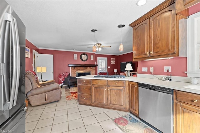 307 Jackson St, Mebane, NC 27302 - kitchen with pendant lighting, crown molding, ceiling fan, stainless steel appliances, and a fireplace