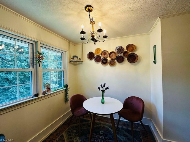 dining space with ornamental molding, a textured ceiling, and a chandelier