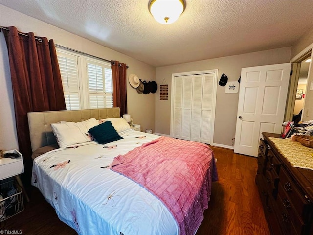 bedroom with dark wood-type flooring, a closet, and a textured ceiling