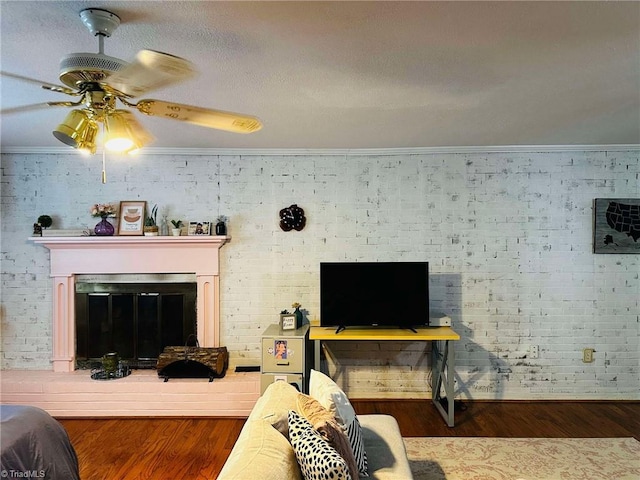 living room featuring dark hardwood / wood-style flooring, ceiling fan, and ornamental molding