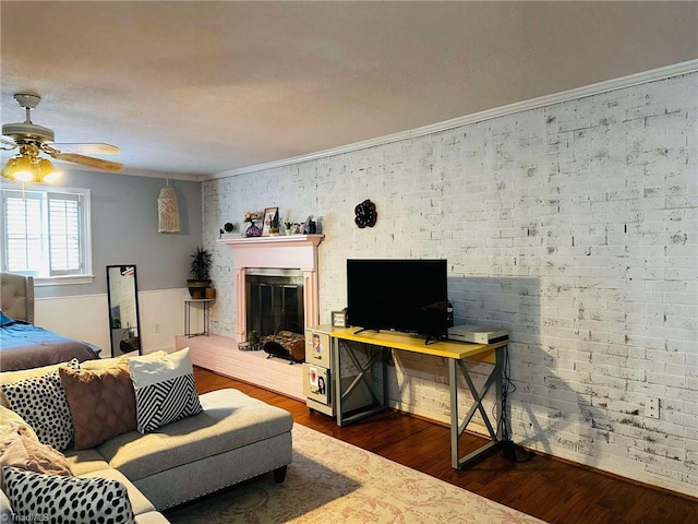 living room with ceiling fan, dark hardwood / wood-style flooring, and ornamental molding