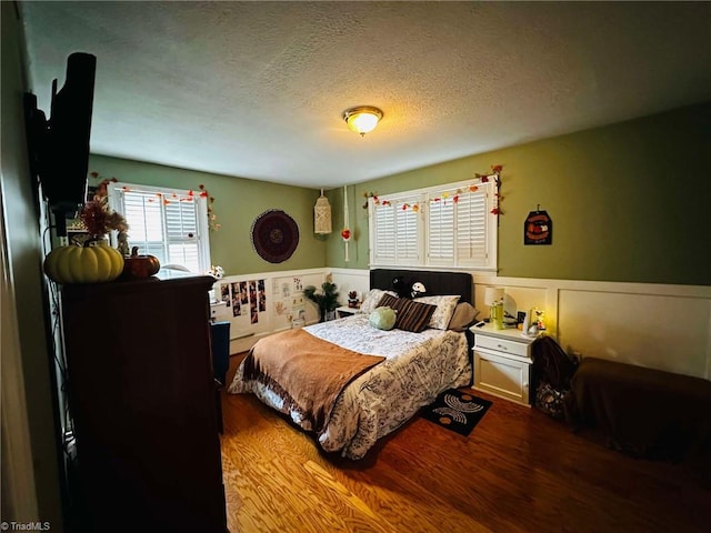 bedroom featuring hardwood / wood-style floors and a textured ceiling