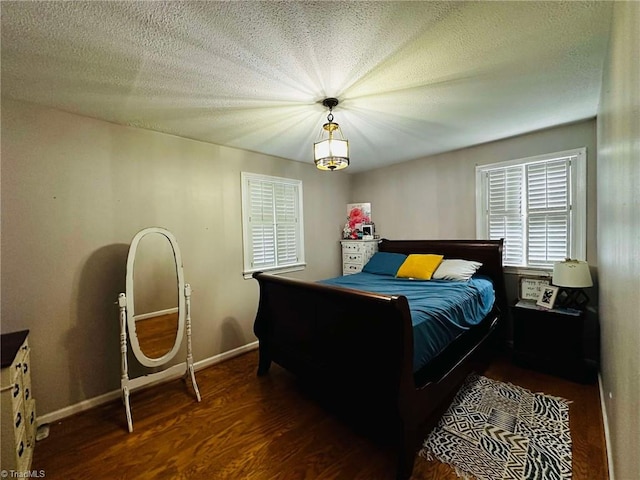 bedroom featuring dark hardwood / wood-style floors and a textured ceiling