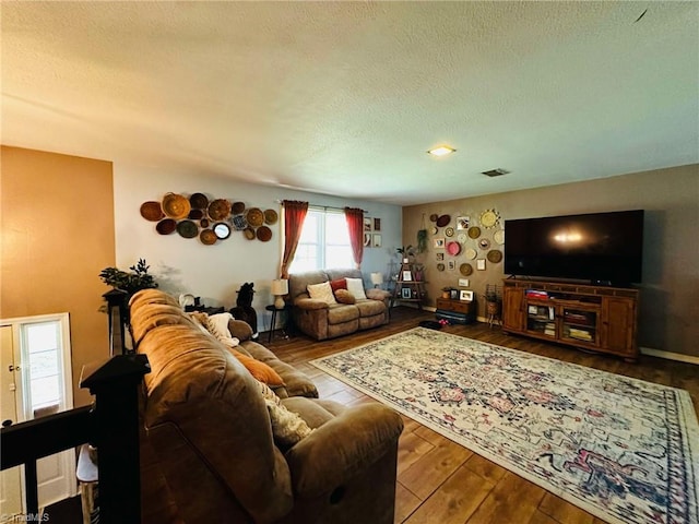 living room featuring hardwood / wood-style floors and a textured ceiling