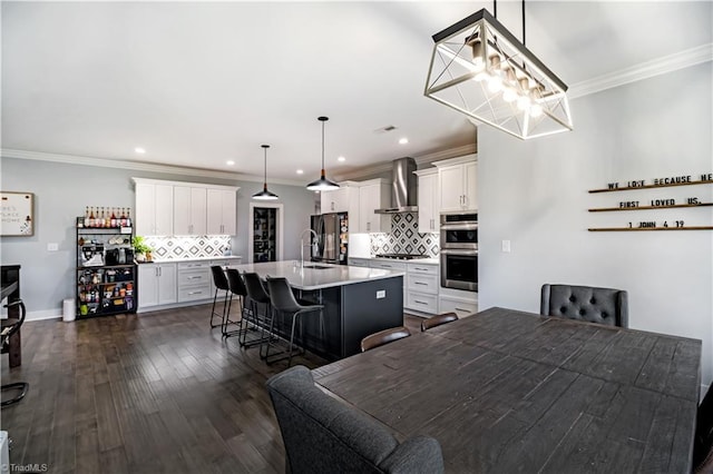 dining area with an inviting chandelier, ornamental molding, and dark hardwood / wood-style floors