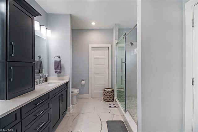 bathroom featuring vanity, toilet, and a shower with shower door