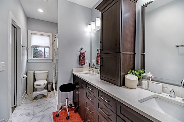 bathroom featuring vanity and toilet