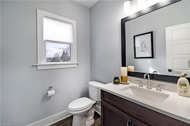 bathroom featuring vanity, hardwood / wood-style floors, and toilet