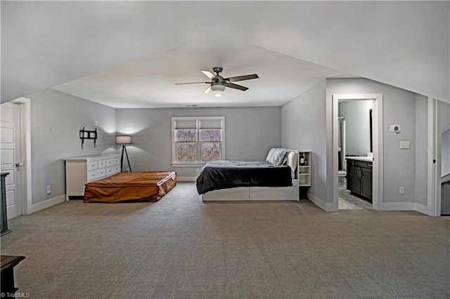 bedroom featuring connected bathroom, light colored carpet, and ceiling fan