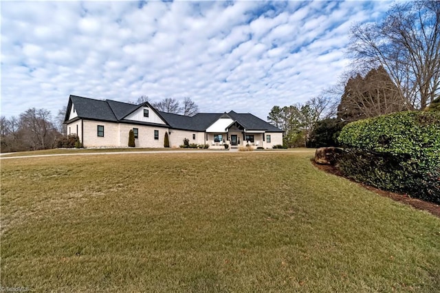 french provincial home with a front yard