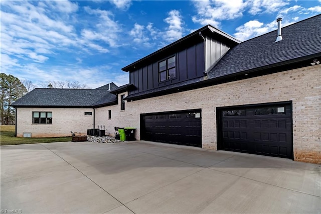 view of side of home featuring a garage and central AC unit