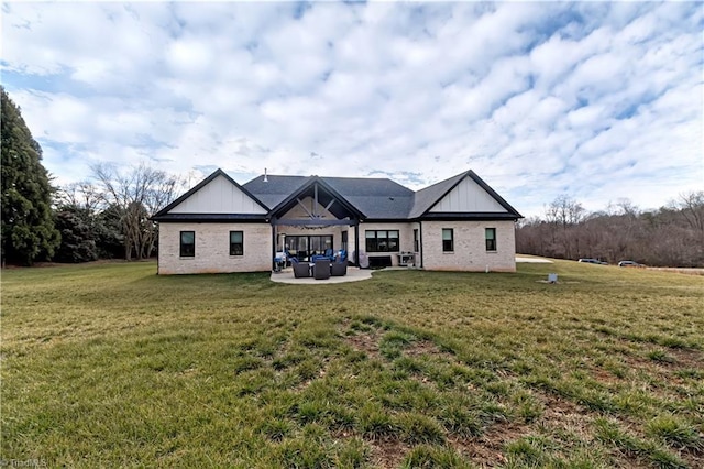 back of house with a patio, outdoor lounge area, and a lawn