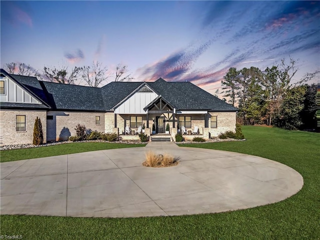 view of front of house with a yard and a porch